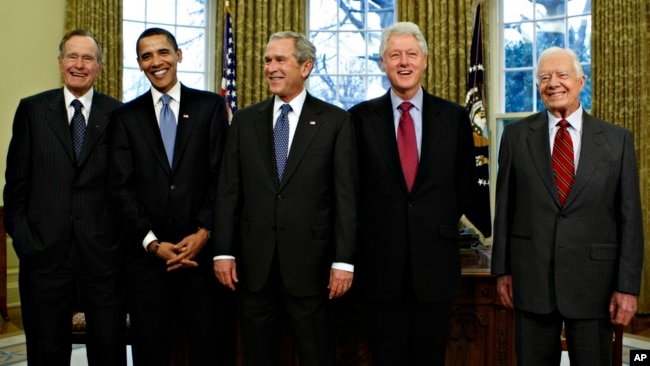 President-elect Barack Obama is welcomed by President George W. Bush for a meeting at the White House in Washington, Wednesday, Jan. 7, 2009, with former presidents, from left, George H.W. Bush, Bill Clinton, and Jimmy Carter.