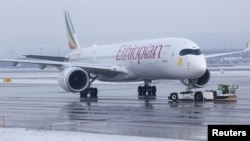 An Airbus A350-941 aircraft of Ethiopian Airlines is pulled by a pushback tractor at Zurich Airport near Ruemlang