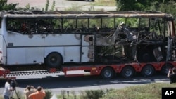 Bus destroyed in a deadly suicide attack on Israeli vacationers is transported out of Burgas airport, Bulgaria, July 19, 2012.