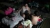 People rest at a makeshift camp outside their apartment building after an earthquake in Yauco, Puerto Rico