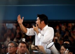 FILE - Thanathorn Juangroongruangkit of Thailand's progressive Future Forward party talks to his supporters during an unauthorized flash mob rally in Bangkok, Thailand, Dec. 14, 2019.