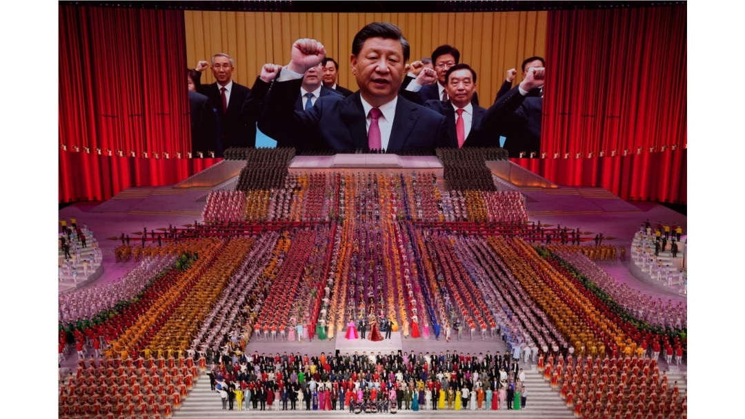 Chinese President Xi Jinping is seen leading other top officials pledging their vows to the party on screen during a gala show ahead of the 100th anniversary of the founding of the Chinese Communist Party in Beijing on June 28, 2021.