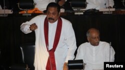 FILE - Sri Lanka's newly appointed Prime Minister Mahinda Rajapaksa speaks during the parliament session in Colombo, Sri Lanka, Nov. 15, 2018.