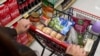 A cart holding groceries is pushed through a supermarket in Bellflower, Calif., on Monday, Feb. 13, 2023.