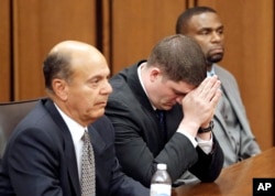 Cleveland police officer Michael Brelo, center, listens to the judge reading his verdict during his trial in Cleveland, Ohio, May 23, 2015.