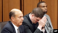 FILE - Cleveland Police Officer Michael Brelo, center, listens to the judge reading his verdict during his trial in Cleveland, Ohio, May 23, 2015.