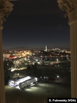 A view from the U.S. Capitol building looking west over the National Mall, with the Washington monument in the background. Trucks used by television crews are parked near the Capitol, in Washington, Jan. 30, 2018.