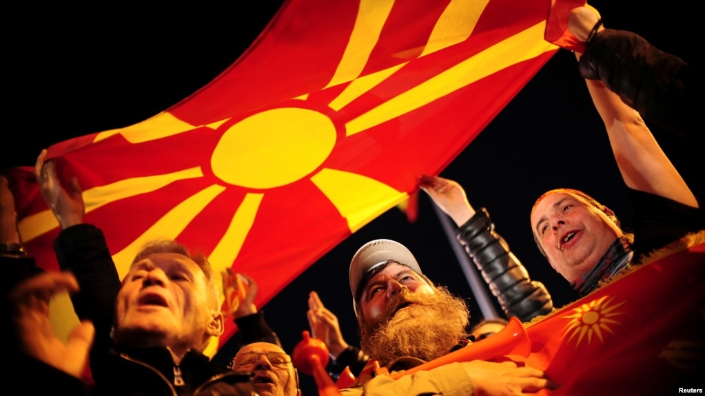 Protesters shout slogans while holding a Macedonian flag during demonstrations against an agreement that would ensure the wider use of the Albanian language in the ethnically divided state, in Skopje, Macedonia, Feb. 28, 2017. 