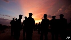 FILE - This photo shows silhouettes of U.N. peacekeepers from Brazil at the airport in Port-au-Prince, Haiti, July 11, 2011. 