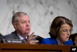 Senate Judiciary Committee Chairman Lindsey Graham, accompanied by Ranking Member Sen. Dianne Feinstein, D-Calif.,(R) questions Attorney General nominee William Barr during a Senate Judiciary Committee hearing on Capitol Hill, Jan. 15, 2019.