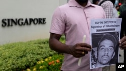 FILE - Activists attend a candlelight vigil against the impending execution of Nagaenthran K. Dharmalingam, sentenced to death for trafficking heroin into Singapore, outside the Singaporean embassy in Kuala Lumpur, Malaysia, Monday, Nov. 8, 2021.