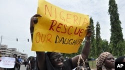 FILE - An unidentified mother cries out during a demonstration with others who have daughters among the kidnapped school girls of government secondary school Chibok, in Abuja, Nigeria.