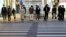 People wearing masks to prevent contracting the coronavirus wait for a signal at a zebra crossing at Dongseong-ro shopping street in central Daegu, South Korea February 21, 2020.   REUTERS/Kim Hong-Ji - RC2Z4F9EQJS7