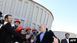 A handout picture released by Iran's Atomic Energy Organisation on December 23, 2019 shows the nuclear water reactor of Arak, south of capital Tehran, during a visit by the head of the organization Ali Akbar Salehi (C). 