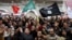 Protesters shout slogans and wave flags during a demonstration in support of the ruling party Ennahda in Tunis February 9, 2013.