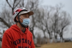 Huang Genben, who spent 67 days in a hospital fighting COVID-19 in 2020, speaks during an interview with AFP in Wuhan, China, Jan. 21, 2021.