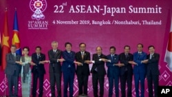 Japan Prime Minister Shinzo Abe, fifth left, poses for a group photo with leader of ASEAN from left; Malaysia Foreign Minister Saifuddin Abdullah, Myanmar leader Aung San Suu Kyi, Philippines President Rodrigo Duterte, Singapore Prime Minister Lee Hsien L