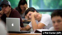 University of Miami student Gabriel Dias studies the daily lesson plan on his computer during a Spanish language class in Coral Gables, Florida