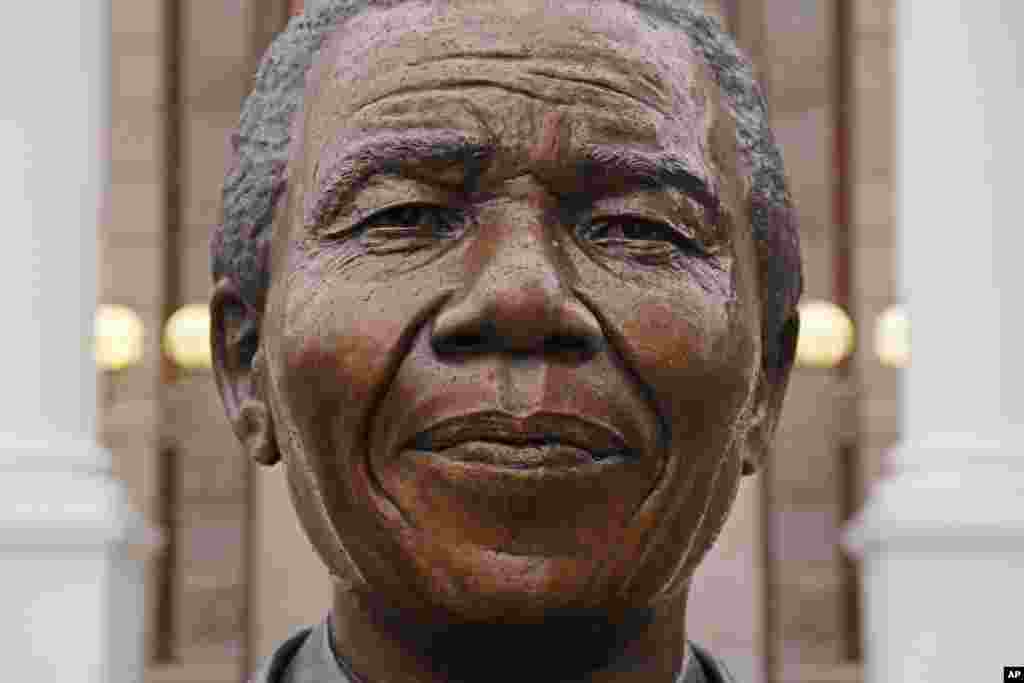 Raindrops fall on the statue of former South African President Nelson Mandela outside parliament in Cape Town, South Africa, Friday, July 18, 2014.