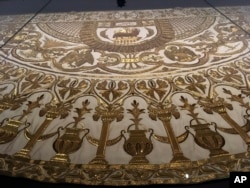 A detail from a papal mantle from the Sistine Chapel sacristy at the Vatican is on display at the Metropolitan Museum of Art in “Heavenly Bodies: Fashion and the Catholic Imagination,” the Spring fashion exhibit at the museum’s Costume Institute, May 5, 2