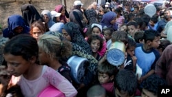 Palestinians line up for food distribution in Deir al-Balah, Gaza Strip, on Oct. 17, 2024.