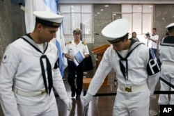 Navy spokesman Enrique Balbi walks away from the podium after taking part in a press conference at Navy headquarters in Buenos Aires, Nov. 29, 2017.