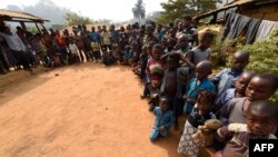 FILE - Cameroonians, including women and children, refugees from the Cameroon's restive anglophone regions, gather for a meeting at Bashu-Okpambe village, in Boki district of Cross Rivers State in Nigeria, Jan. 31, 2018.