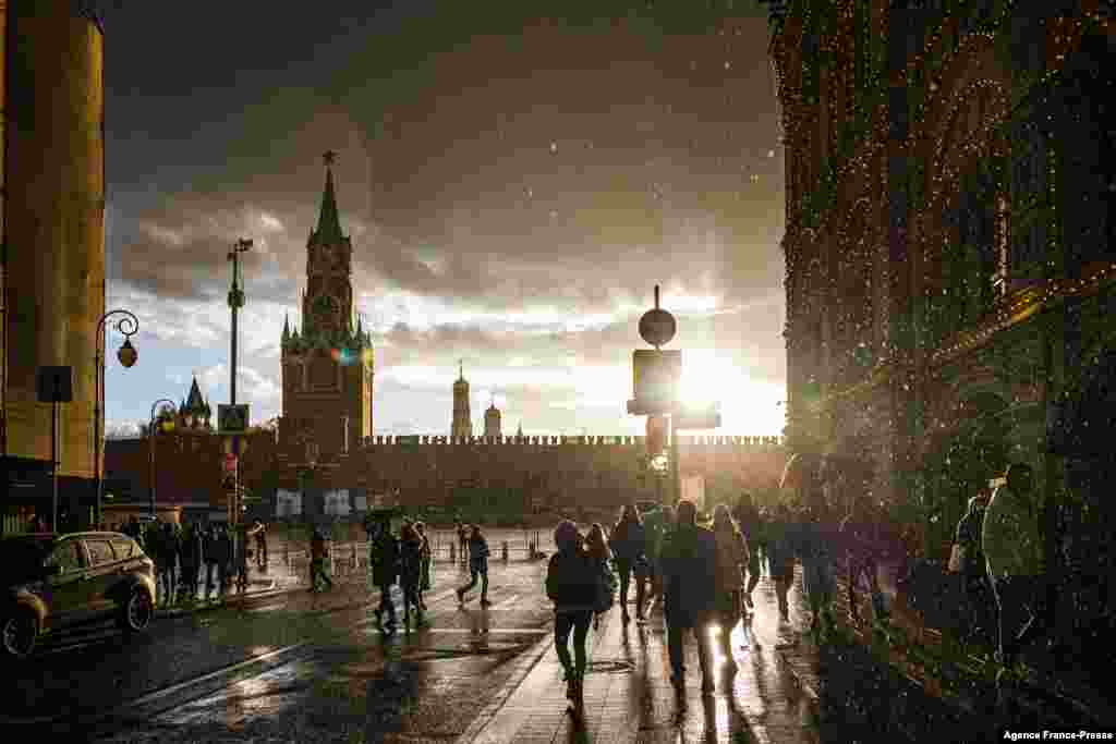 People cross the Red Square in Moscow, Russia, Oct. 23, 2021.