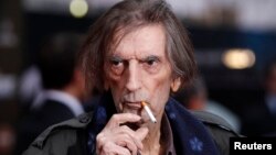 FILE - Actor Harry Dean Stanton smokes a cigarette as he poses at the world premiere of the film "Marvel's The Avengers" in Hollywood, California, April 11, 2012. 