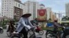 Motorcyclists and cyclists ride on a street inside a newly-developed residential area in Hanoi on May 7, 2013. 