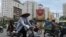 Motorcyclists and cyclists ride on a street inside a newly-developed residential area in Hanoi on May 7, 2013. 