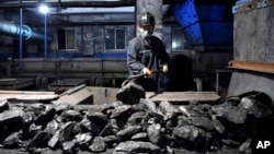 FILE - A worker sorts coal at a mine in Suzhou, China, on Oct. 20, 2021. China relies on coal for most of its energy production. U.S. climate envoy John Kerry described meetings with his Chinese counterpart as "productive," on Nov. 10, 2023.