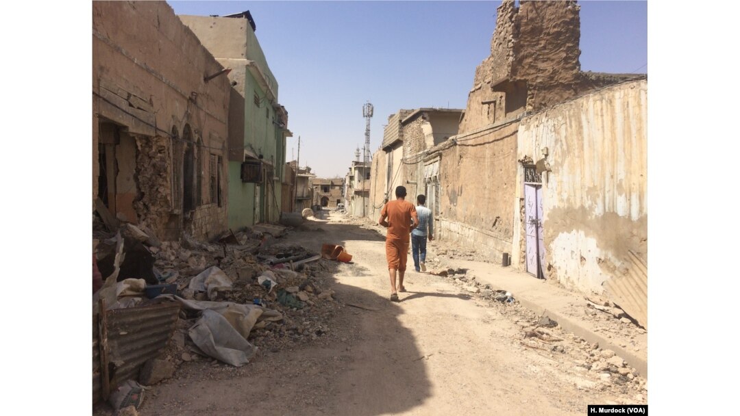 Families visit their homes in Mosul's Old City but say its too dangerous to move back home, Sept. 29, 2017.
