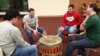 Native American students drum and sing together in a ceremony at the University of Wisconsin-Madison.