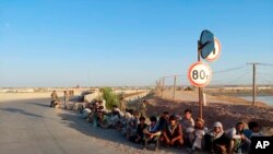 Afghan military personnel crossed the Tajikistan border from Afghanistan's Badakhshan province as Taliban fighters advanced toward the border, June 22, 2021. (Source: Republic of Tajikistan)