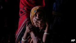 Hagar Yahia holds her 5-year-old daughter Awsaf, who is suffering from malnourishment from living mainly off of bread and tea, in this Feb. 9, 2018 photo in Abyan, Yemen. (AP Photo/Nariman El-Mofty)