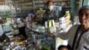 A man wears a mask as he waits for customers at his drugstore in Pailin in western Cambodia, January 2010. (file photo)