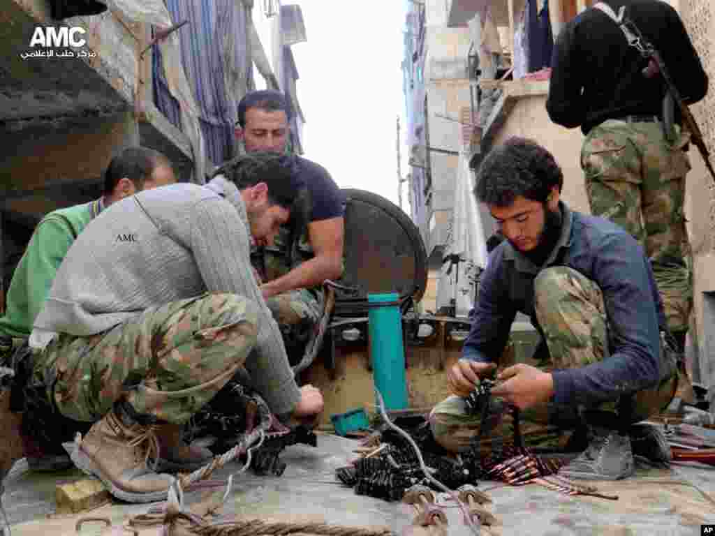 This citizen journalism image shows members of the free Syrian Army preparing their weapons, in al-Amerieh, Aleppo, Syria, April 25, 2013. (Aleppo Media Center AMC)