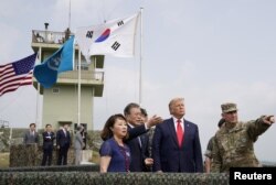 U.S. President Donald Trump and South Korean President Moon Jae-in visit the demilitarized zone separating the two Koreas, in Panmunjom, South Korea, June 30, 2019. REUTERS/Kevin Lamarque