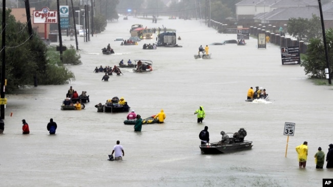 In this file photo, rescue boats float on a flooded street as people are evacuated from rising floodwaters brought on by Tropical Storm Harvey on Aug. 28, 2017, in Houston, Texas. (AP)