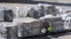 FILE - An air cargo employee checks pallets of imported items, at Miami International Airport in Miami, Feb. 7, 2025. Some experts say new tariffs on imported goods are partly to blame for February's drop in consumer confidence.