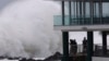 People watch as huge swells hit the beaches on the Gold Coast, Australia, March 6, 2025.