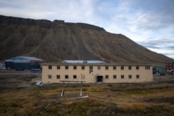 FILE - An empty fissured building, evacuated after its foundation has moved due to the melting of the permafrost is seen in Longyearbyen on Svalbard island, Sept. 25, 2021.