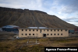 FILE - An empty fissured building, evacuated after its foundation has moved due to the melting of the permafrost is seen in Longyearbyen on Svalbard island, Norway, Sept. 25, 2021.
