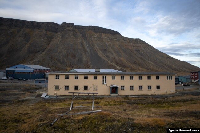FILE - An empty fissured building, evacuated after its foundation has moved due to the melting of the permafrost is seen in Longyearbyen on Svalbard island, Norway, Sept. 25, 2021.