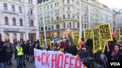 Angry demonstrators carrying a banner with obscene language march in protest against far-right presidential candidate Norbert Hofer in Vienna, Dec. 3, 2016. (L. Ramirez/VOA)