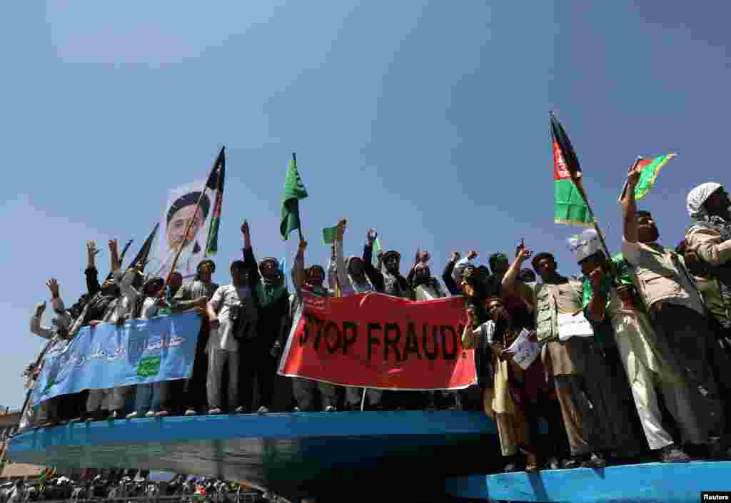 Afghans protest in support of presidential candidate Abdullah Abdullah, in Kabul, June 27, 2014. 