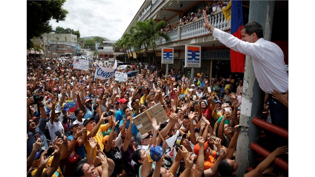 FILE - Venezuelan opposition leader Juan Guaido, who many nations have recognized as the country's rightful interim ruler, greets supporters during a gathering in Charallave, Venezuela, June 8, 2019.