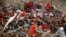 A Bangladeshi rescuer stands amid the rubble of a garment factory building that collapsed on April 24 as they continue searching for bodies in Savar, near Dhaka, Bangladesh, May 12, 2013.
