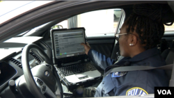 Arlington County Police Officer Patrice Malone checks the computer in her cruiser. (Mike Burke/VOA)